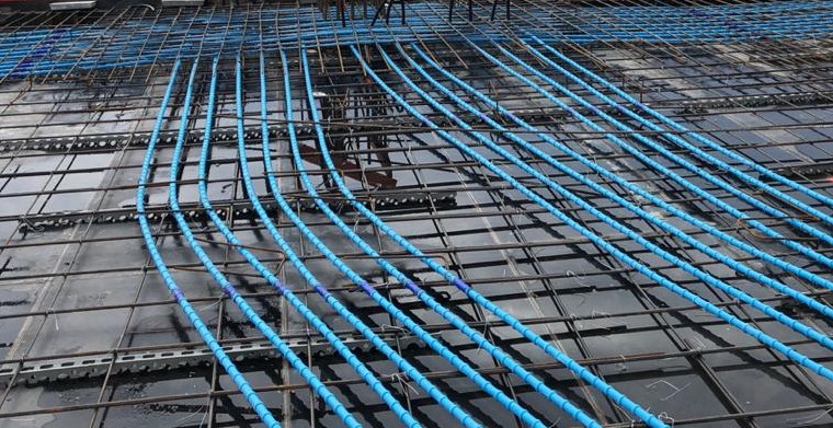 Close-up of multistrand internal post-tensioning being installed on a building site by VSL.